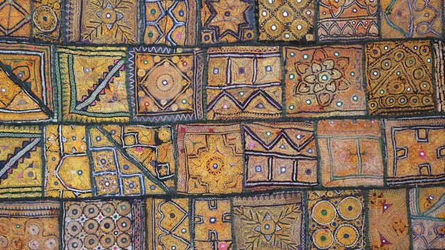 Detail old colorful patchwork carpet, establishing shot. Close up