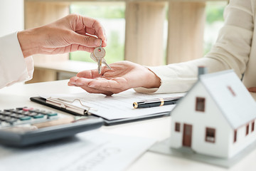 Real estate agent and customer signing contract to buy house, insurance or loan real estate.
