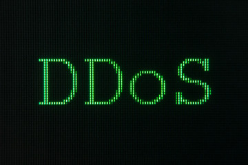 Green sign of DDoS, Distributed Denial of Service, displayd on computer screen