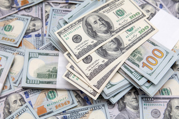 One hundred dollar bills on the table as background