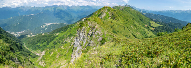 Fototapeta na wymiar View of the high mountain range with cable cars. Aibga Ridge, Krasnaya Polyana, Sochi, Russia.