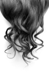 Naklejka premium Natural wavy black hair on white background