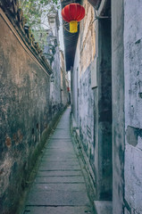 Narrow alleyway between old walls in the old town of Xitang, China