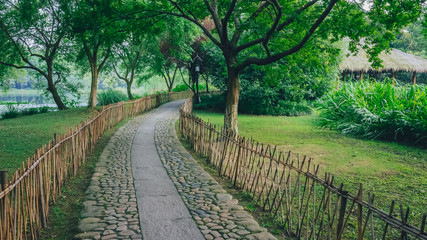 Fototapeta premium Path leading to a hut among tree, near West Lake, Hangzhou, China