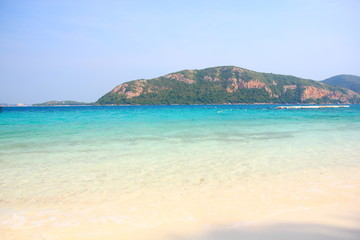 Beach and tropical sea, water clear,and have mountain on blue sky.Koh kham ,Pattaya Chonburi.