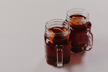 Mulled wine in mugs  on white wooden table.