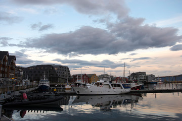 Port w Tromso, Norwegia. Widoczne łodzie i budynki.