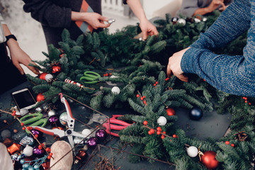 Christmas tree wreath decoration with man hand workshop DIY