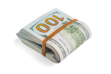 stack of cash dollars, bent in half, under the elastic band is isolated on a white background. Close-up.