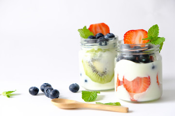 Strawberry yogurt, blueberry, kiwi, placed in a glass cup, placed on the table