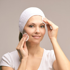 Beauty woman natural makeup. Remove mascara. Cotton pad