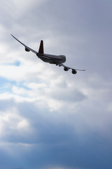 Airplane flying over cloudy sky. Commercial travel airline concept. Turn right.