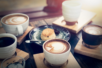 Breakfast with coffee and bread on wooden table.