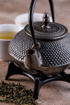 Traditional Japanese herbal tea, cooked in a cast-iron kettle with organic dry herbs. Close-up.