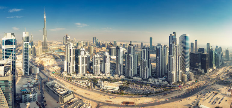 Aerial panorama view on downtown Dubai, UAE. Skyscrapers of the business bay on a summer day.