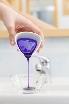 Woman Pouring Purple Hair Dye Or Shampoo