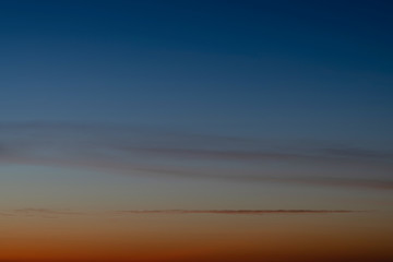 Fototapeta premium Sky gradient from blue to orange sunset