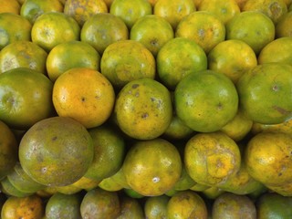 Healthy fruits. Pile of fresh orange. Fresh orange fruits background.