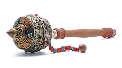 Tibetan hand prayer wheel. Isolated on white background