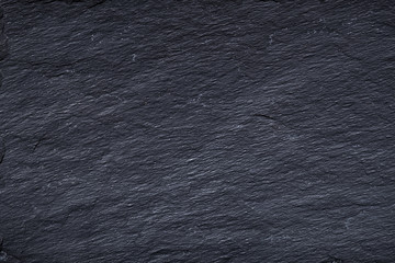 Dark gray black slate background or texture of natural stone.