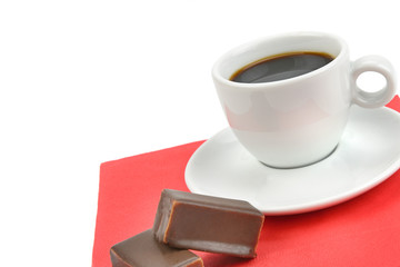 A cup of coffee and chocolate candy isolated on white background