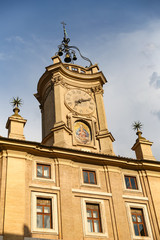 Obraz premium Clock Tower over a Building in Rome, Italy