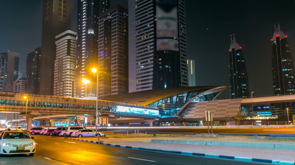 Fototapeta na wymiar Downtown Dubai towers night timelapse. Vew of Sheikh Zayed road with skyscrapers.