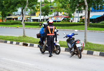 Traffic police stopping and check motorcycle / traffic policeman on the streets and motorcycle rider