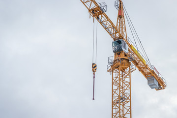 yellow construction crane against blue sky