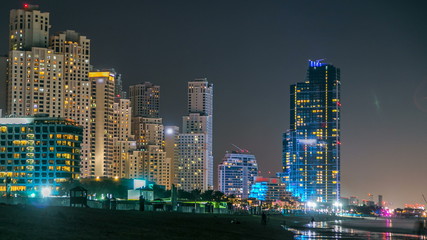 Fototapeta na wymiar View of modern skyscrapers night timelapse in Jumeirah beach residence in Dubai, JBR