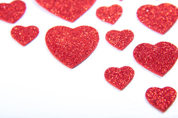 Valentine's Day, silver and red hearts on a white background with empty space