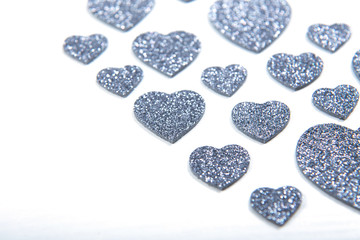 Valentine's Day, silver and red hearts on a white background with empty space