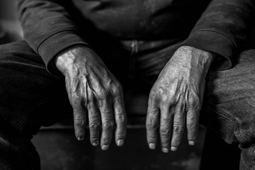 Old, tired ,  resting caucasian man hands close up shot, conceptual aging image for background in black and white.