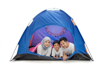 Asian family lying together in the tent