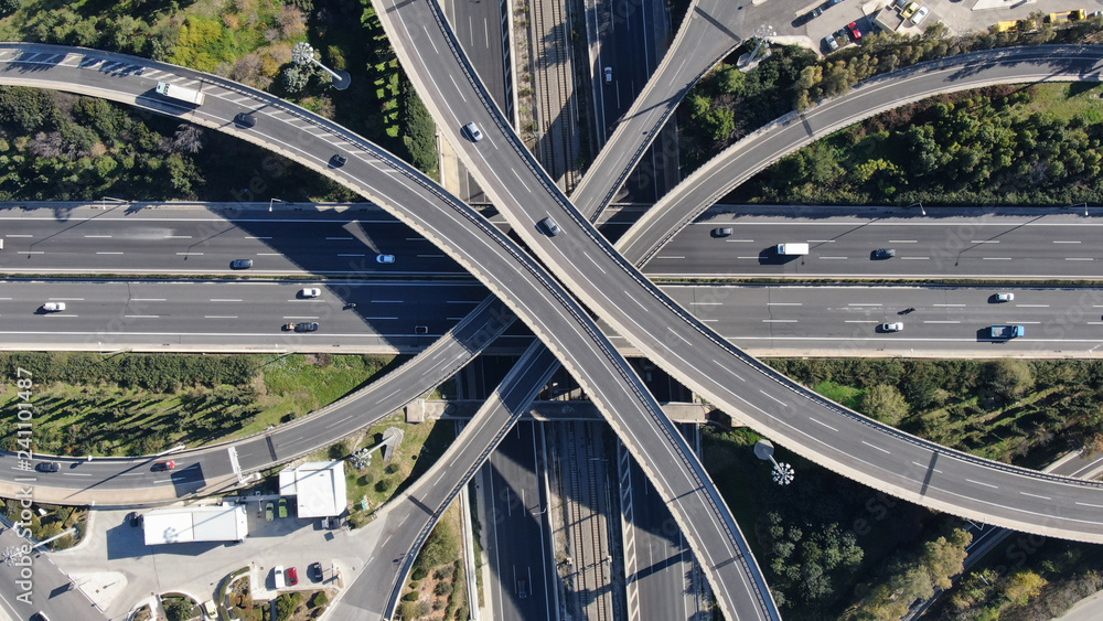 Wall mural Aerial photo of multilevel elevated highway junction highway passing through modern city in multiple directions