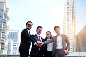 Group of business people stand congratulated.