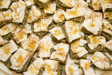 horizontal image with close detail of lard nuggets with walnuts and wholemeal bread a typical antipasto of Italian cuisine