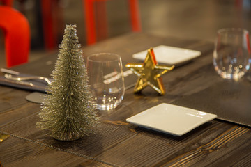 Naklejka na ściany i meble horizontal image with detail of a restaurant table prepared for two, in the evening with Christmas decorations