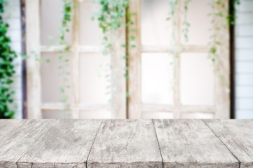 empty wooden desk over blurred interior decoration background