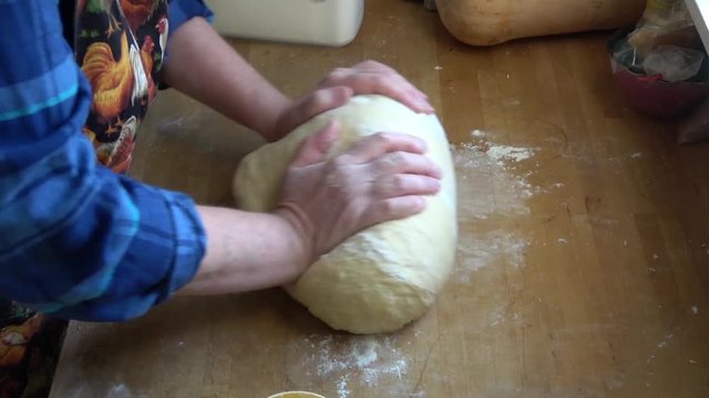Home baker in final stretch of kneading process on bread dough