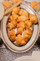 horizontal image with a close-up detail of filled fresh nuggets, served on a steel tray