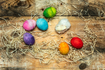 beautiful, bright, very colorful hand-painted eggs on a contrasting, raw, natural background from wooden planks