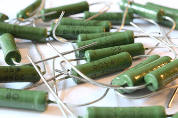 A heap of big ceramic green power resistors with 1.5 KOhm resistance and 5 Watt power dissipation, with axial horizontal through hole mount, with pins