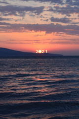 Newyear 2021 concept. silhouette of inscription 2021 against the background of the mountains and...