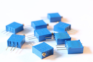 A heap of three pins, through hole, 27 KOhm small blue adjustable resistors, or trimmers, with multi turn precision shaft, with slot drive, for pcb