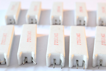 A heap of big ceramic white power resistors with 120 Ohm resistance and 5 Watt power dissipation, with vertical radial through hole mount, with pins