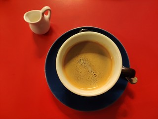 coffe with milk on red table