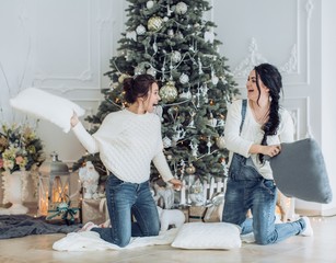 Portrait of two beautiful young girls is in Christmas sceneries