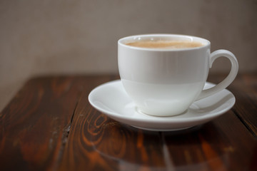 Hot coffee in a white cup on the table