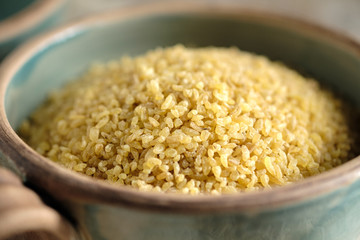Bulgur groats in ceramic dishes
